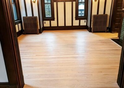 Image of a newly refinished, natural color flooring.