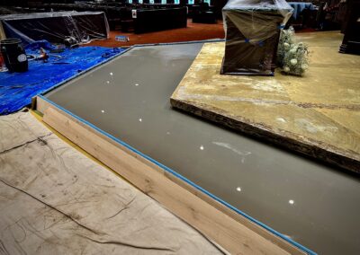 Self-leveling compound curing on first altar platform after pour