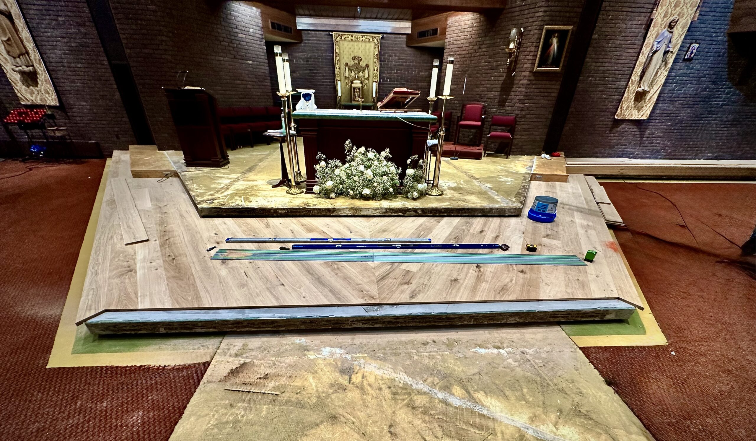 First altar platform field flooring installed with left and right nosing in place and front nosing area cut and prepared