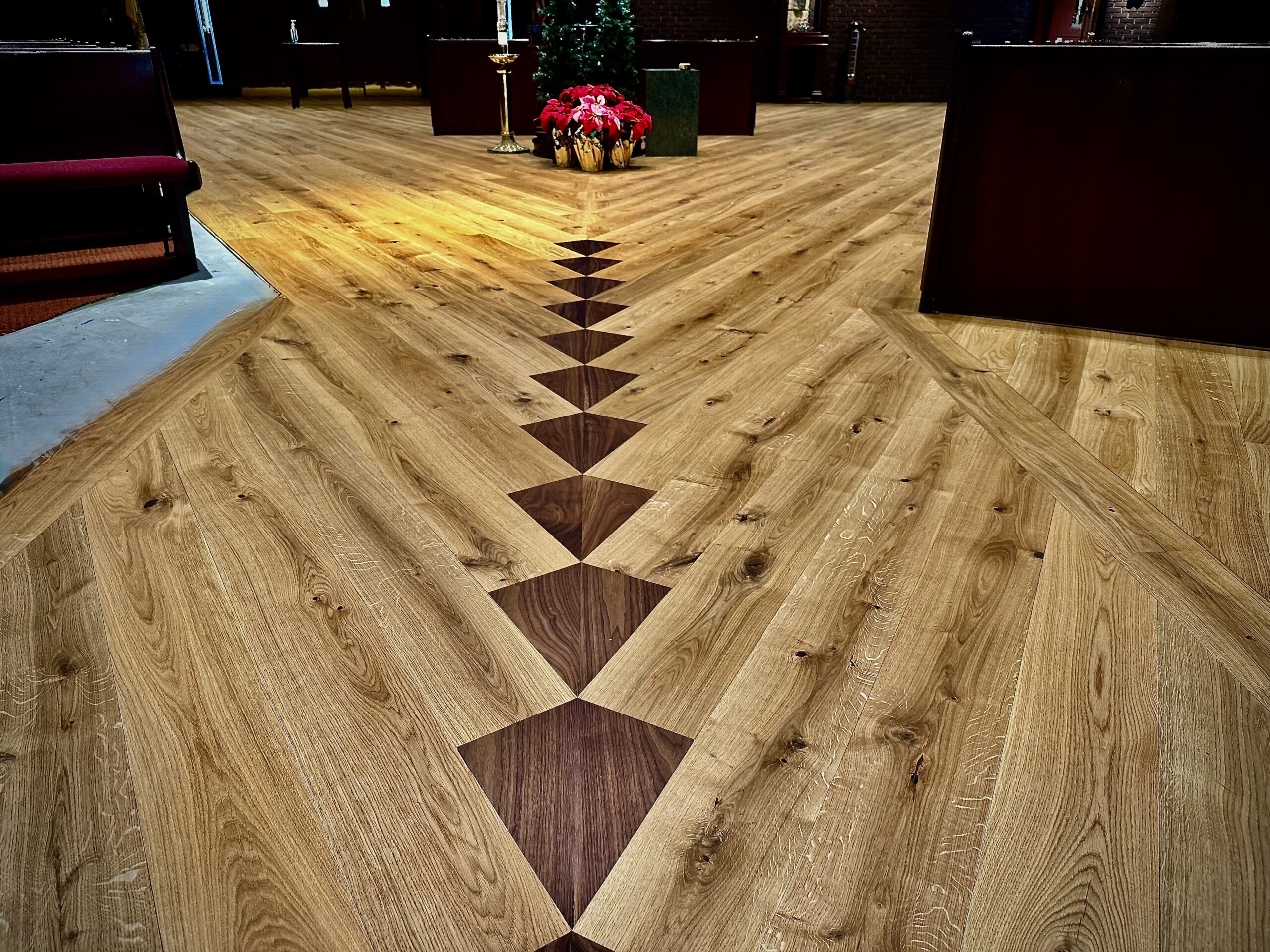 Walnut diamond pattern in the center aisle of a church sanctuary, precision hardwood floor layout